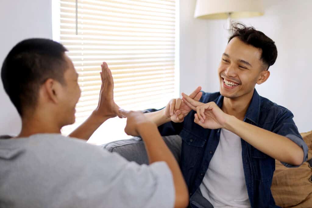 Two men smiling and enjoying recovery at a Residential Rehab in Huntington Beach, CA