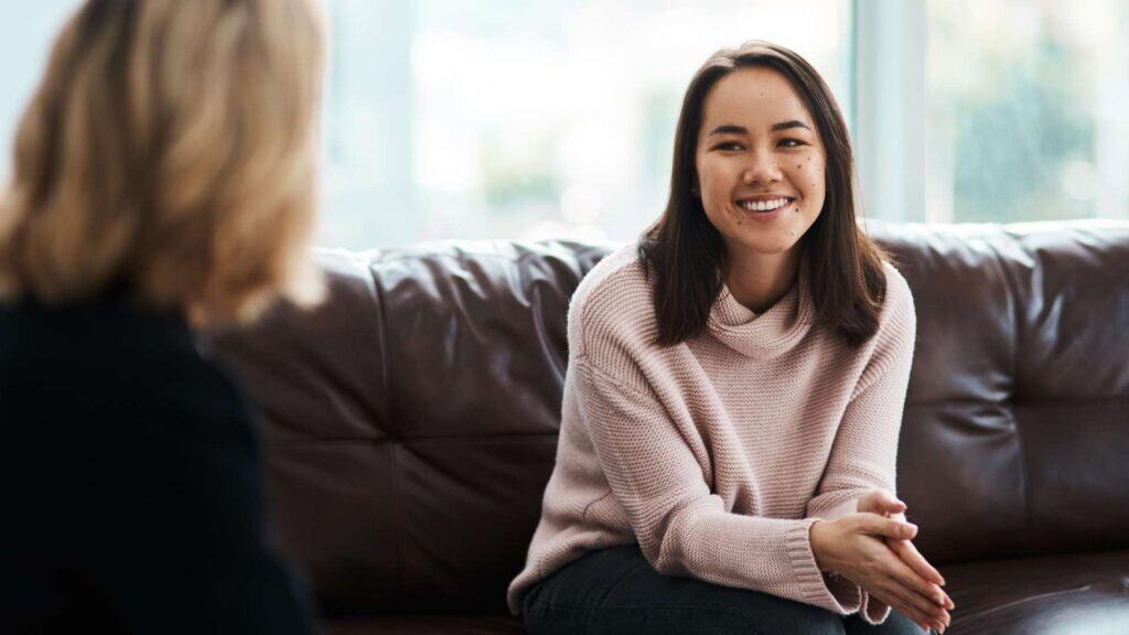 Smiling woman in counseling session receiving Dual Diagnosis Treatment in Huntington Beach, CA