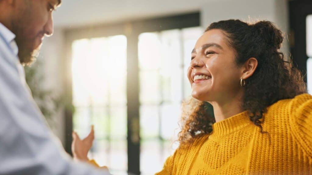 Smiling woman engaged in conversation during a relapse prevention program in Huntington Beach, CA