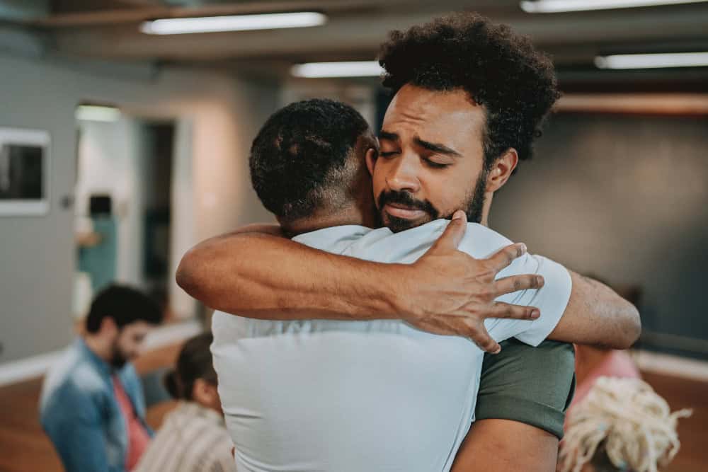 Support group members embracing after completing Alcohol Detox in Huntington Beach, showing compassion, strength, and renewed connection.