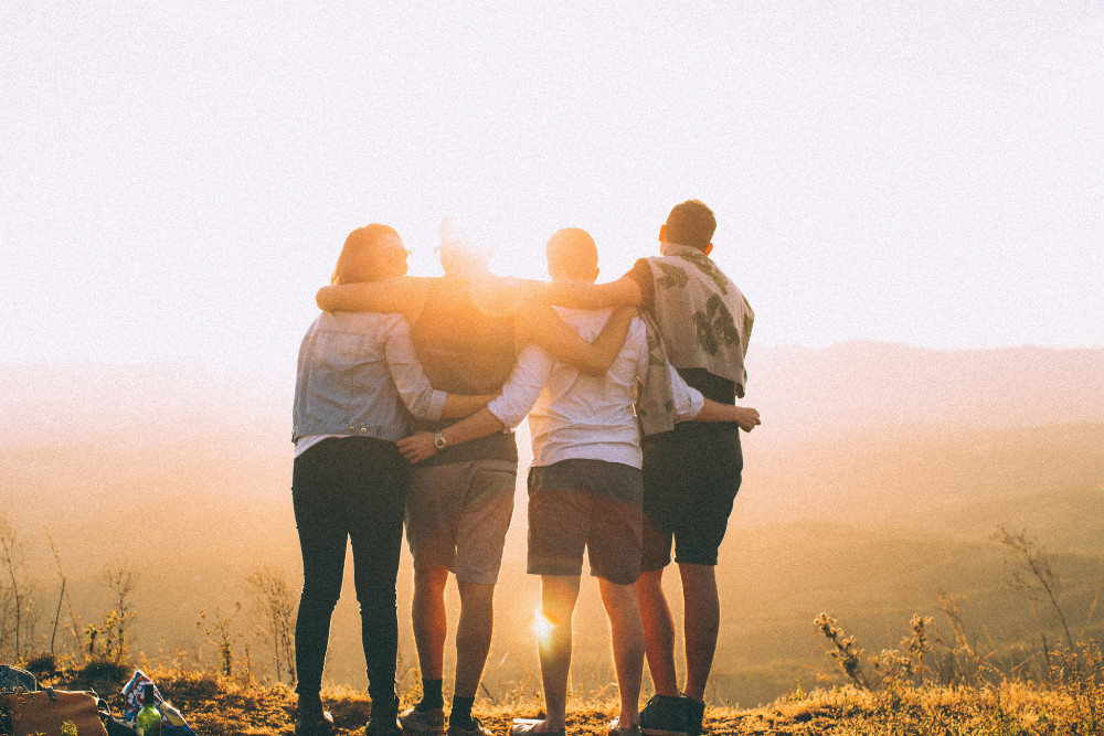 Friends embracing at sunset after completing Drug Detox in Huntington Beach, symbolizing hope, recovery, and new beginnings.